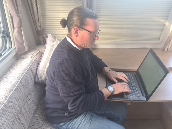 Me working on my laptop in my caravan.