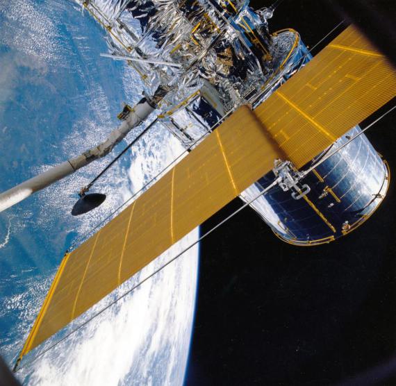 A satelite in space above the earth.