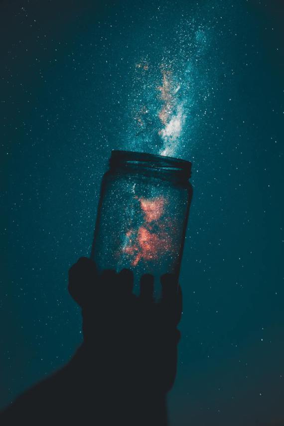 A jar held infront of the milky way.