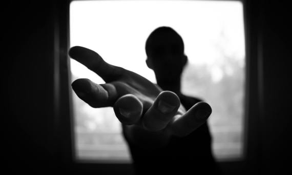 A man with an outstretched arm, as if offering a helping hand.