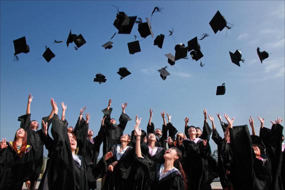 A university graduation with everyone throwing thier hats in the air.