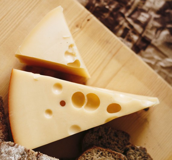Some cheese on a board.